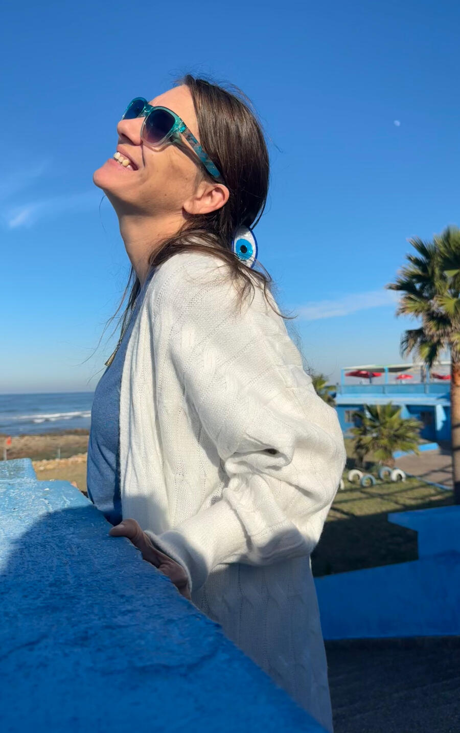 Erin finding peace on the beach in Morocco Erin standing peacefully on a Moroccan beach, symbolizing self-reflection and inner healing